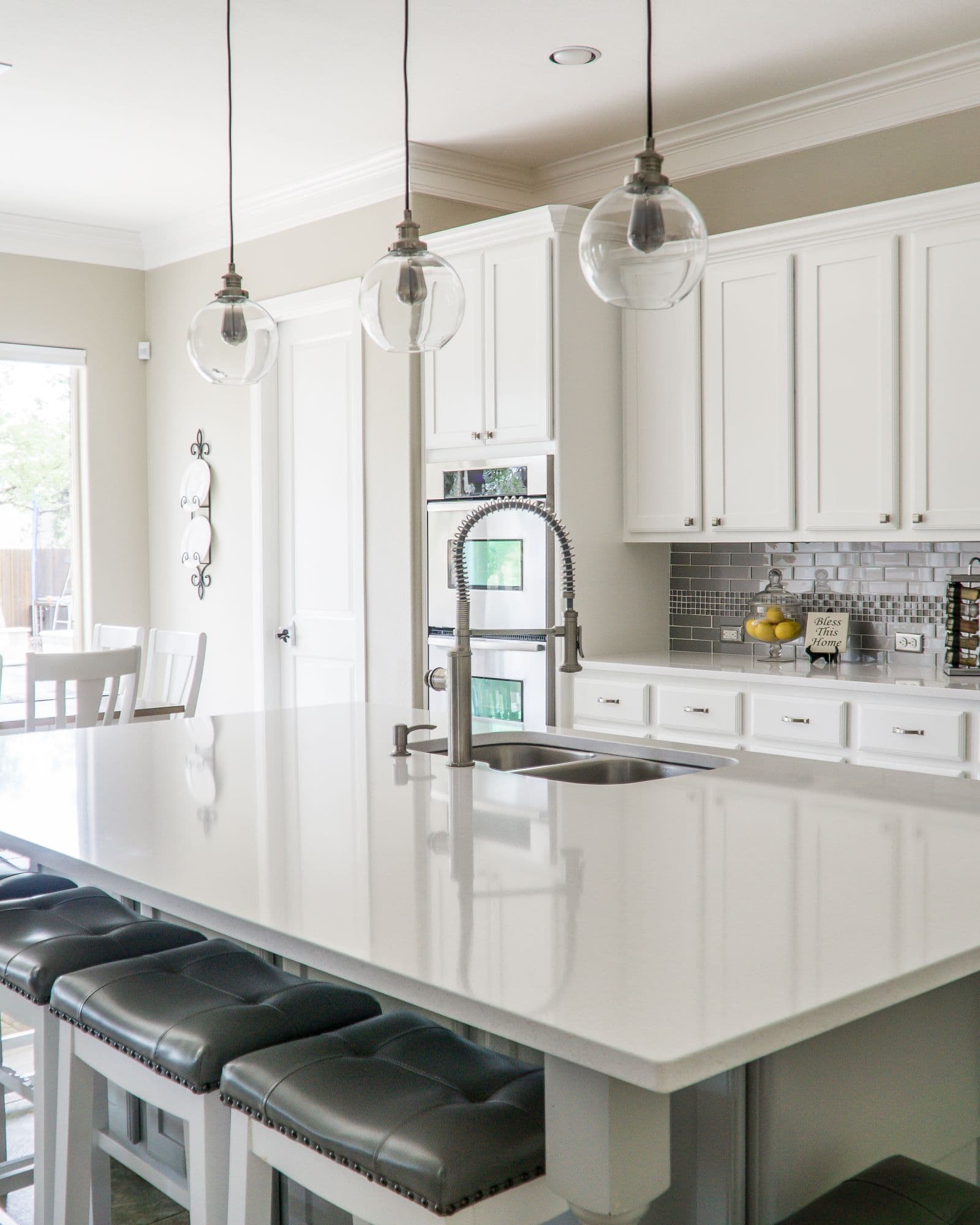 Bright modern kitchen with an island sink and faucet